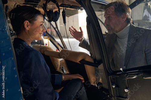 Aircraft hangar manager conversing with female in chopper photo