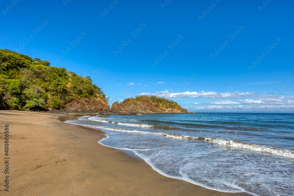 pacific ocean waves on Playa Ocotal, El Coco Costa Rica. Famous snorkel beach. Picturesque paradise tropical landscape of Costa Rica beach. Pura Vida concept, travel to exotic tropical country.
