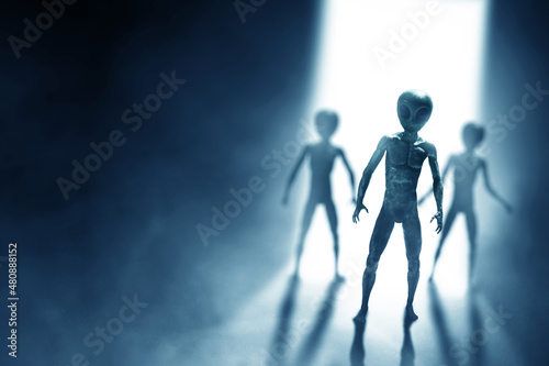 Silhouettes of aliens creature on dark background.