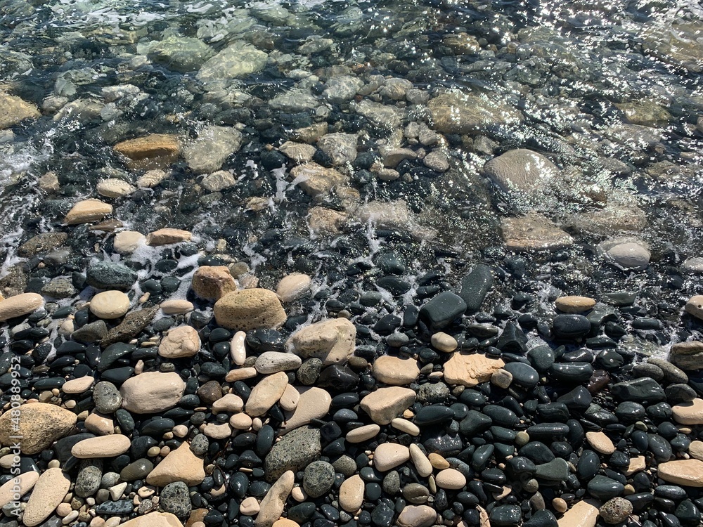 Big sea pebble and transparent water, natural background, sea coast Big sea pebble and transparent water, natural background, sea coast