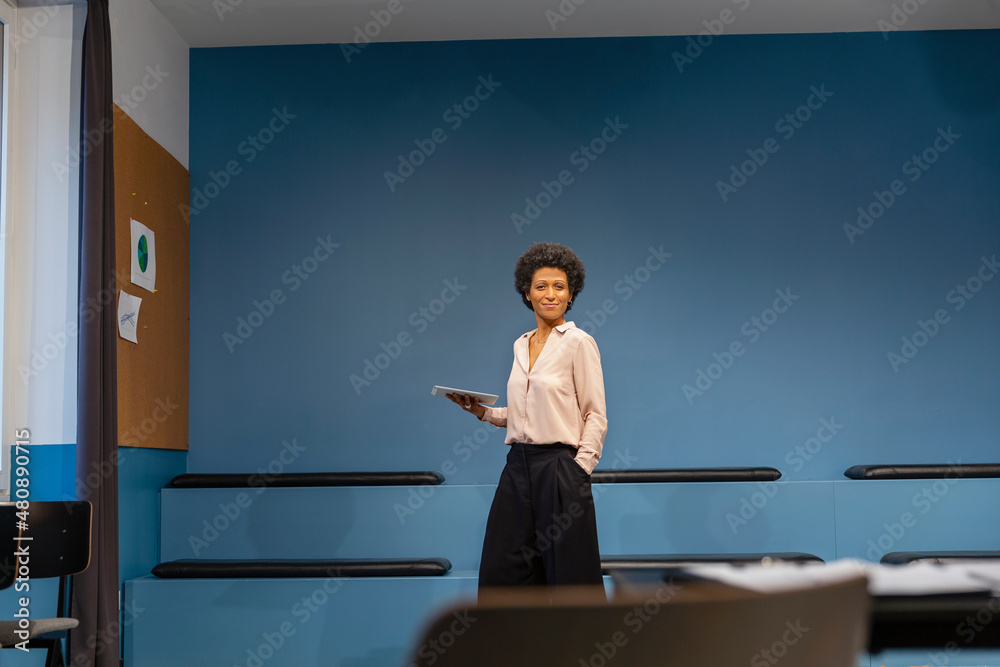 Smiling businesswoman with tablet PC in board room Smiling businesswoman with tablet PC in board room