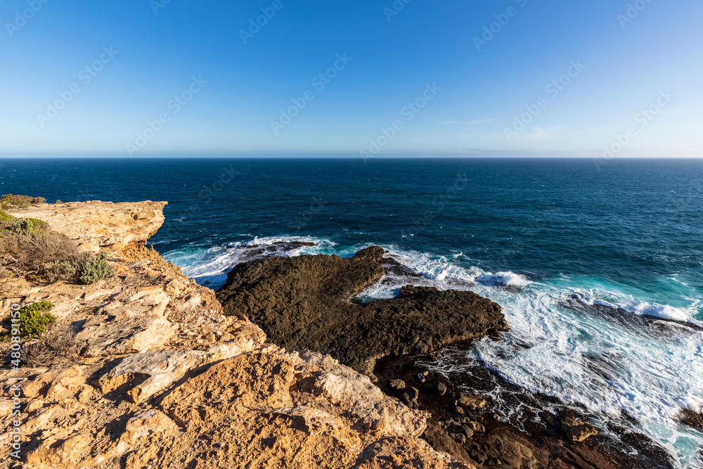 Australia, Victoria, Shore of Cape Nelson State Park with clear line of horizon over sea in background Australia, Victoria, Shore of Cape Nelson State Park with clear line of horizon over sea in background