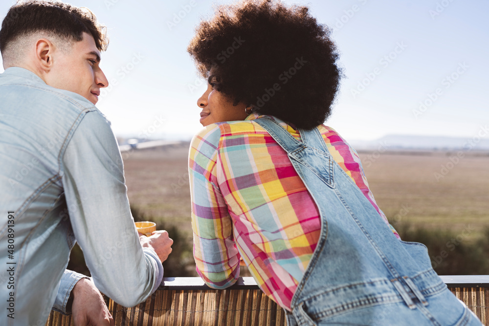 Young couple looking at each other on balcony Young couple looking at each other on balcony