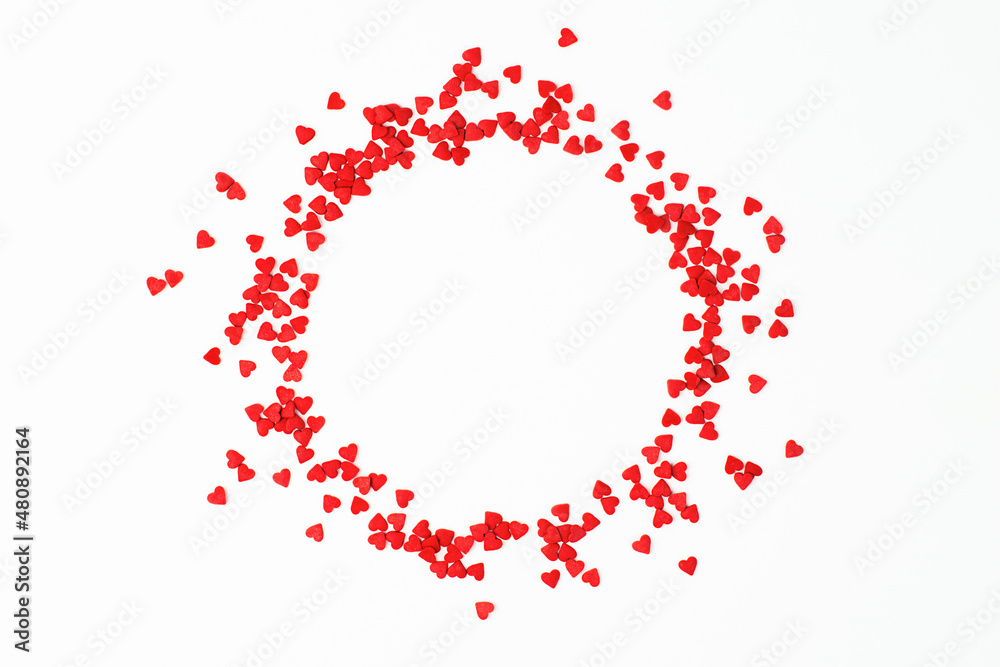small hearts are scattered in the shape of a circle on a light background, a design element for valentine's day