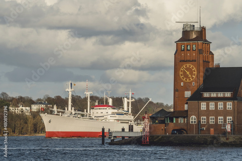 Germany, Hamburg, Cap San Diego moored in front of clock tower in Finkenwerder photo