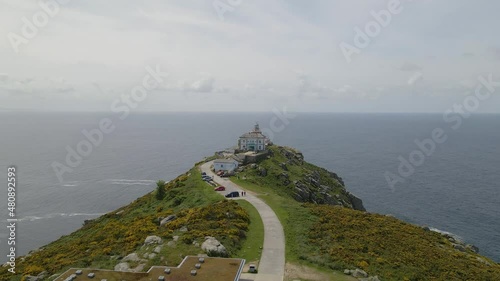 Aerial view of Cabo Finisterre, Galicia, Spain. Lighthouse on a mountain by sea with rock cliff. photo