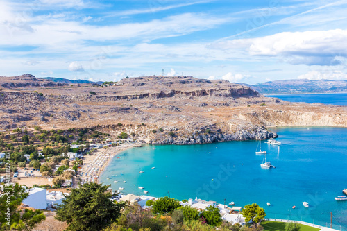 Boats in blue sea near beach on sunny day, Lindos, Rhodes, Greece