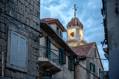 Illuminated bell tower under cloudy sky at dusk, Split, Dalmatia, Croatia photo