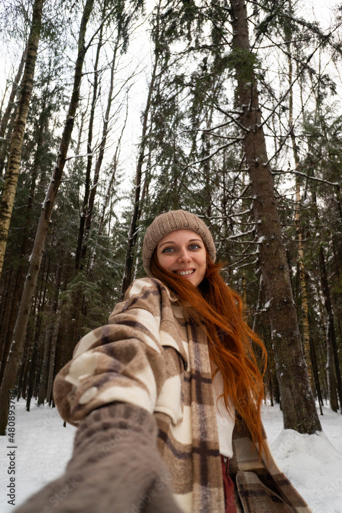Smiling woman in winter forest on vacation Smiling woman in winter forest on vacation