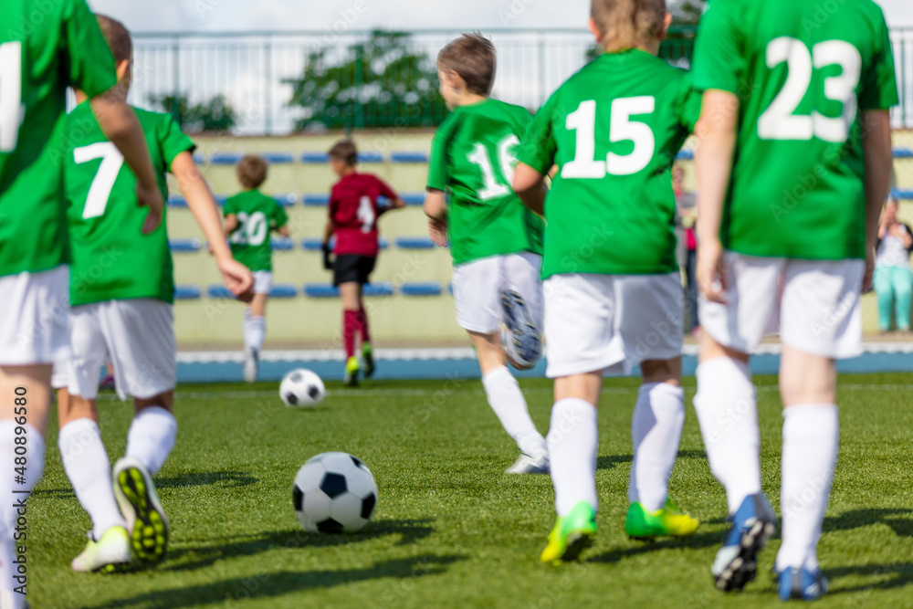 Obraz premium Football Class For Youth. Soccer Training With Coach For School Boys. Sporty Boys Running With Balls During Exercises. Ball Control Training