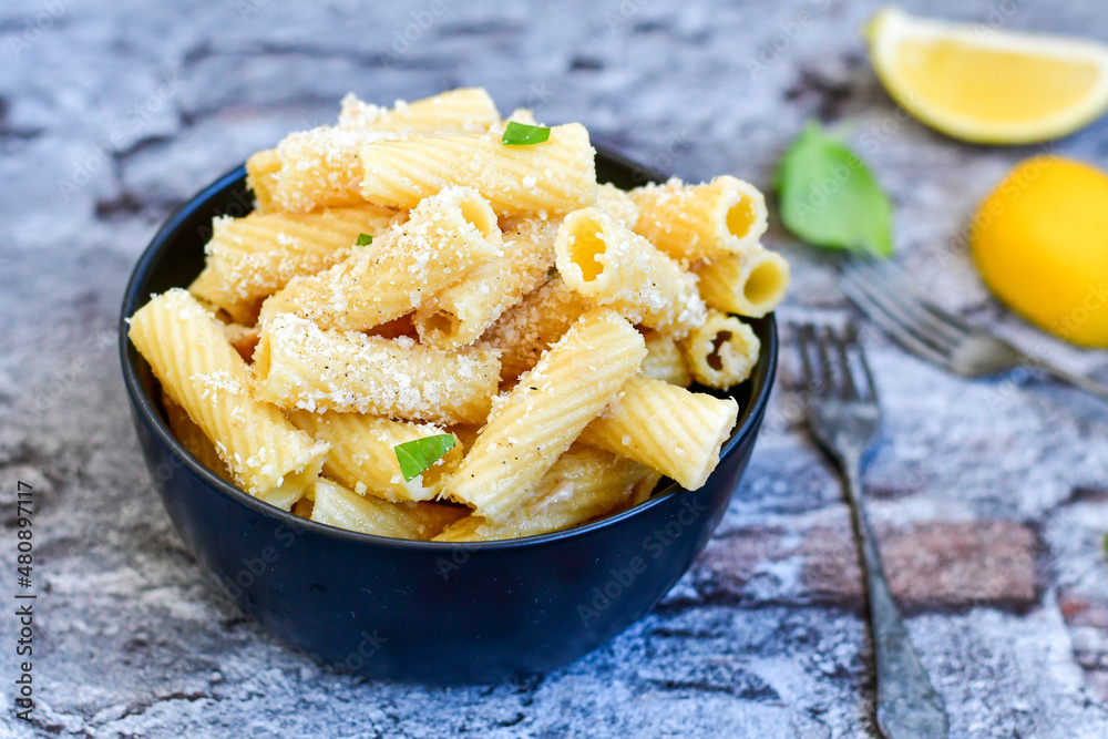 Italian home made rigatoni pasta with tuna fish, parmesan cheese and black pepper . Italian home made rigatoni pasta with tuna fish, parmesan cheese and black pepper .
