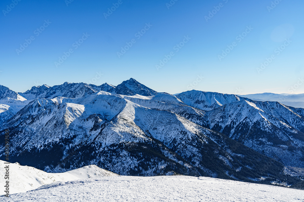 Snow-covered and icy hiking trails in the Polish Tatras with a view of the surrounding high peaks. Snow-covered and icy hiking trails in the Polish Tatras with a view of the surrounding high peaks.