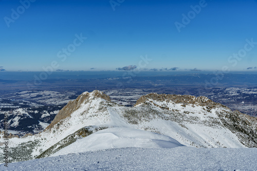View from the Tatra Mountains towards the Beskids with the Giewont mountain and towns below