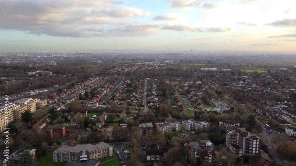 Slow drone shot flying over British suburban town at sunset Slow drone shot flying over British suburban town at sunset