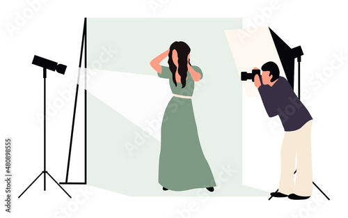 Professional photographers taking pictures. Men and woman models posing in professional photography studio with cameras and light tripods.