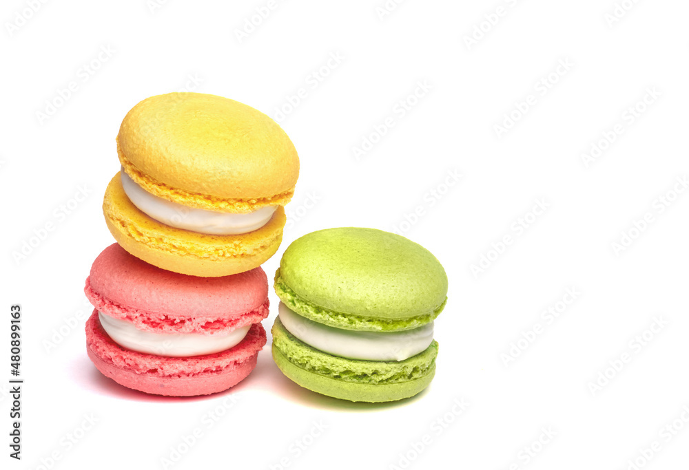 Banner of colorful macaroons isolated on white background. Lemon yellow, strawberry pink and green french cookies. Caramel hazelnut and strawberry cakes in front view. Bakery concept with blank space Banner of colorful macaroons isolated on white background. Lemon yellow, strawberry pink and green french cookies. Caramel hazelnut and strawberry cakes in front view. Bakery concept with blank space