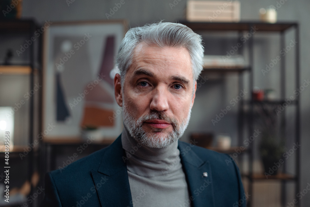 Close up of mature businessman indoors in office, looking at camera. Close up of mature businessman indoors in office, looking at camera.