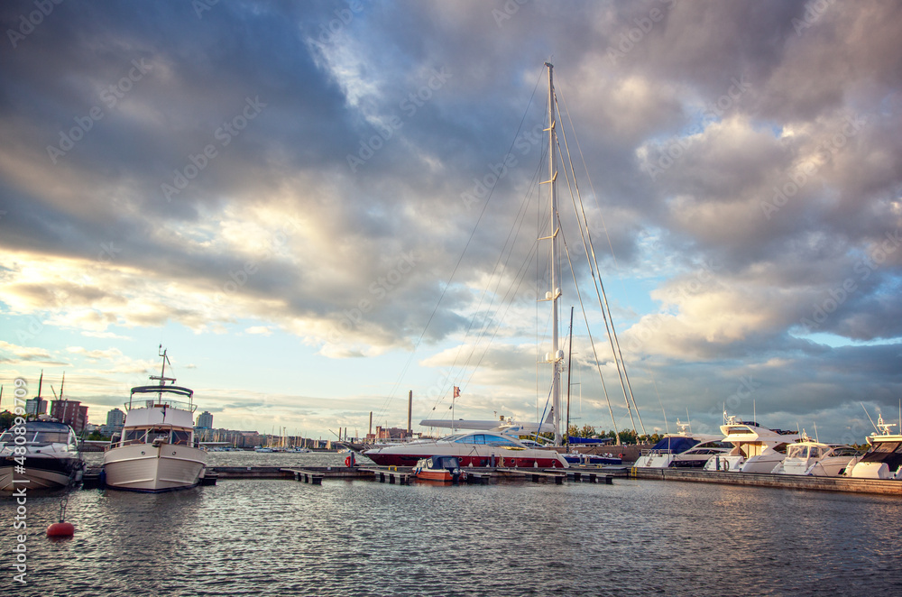 Port in european city with white boats and yachts at sunset