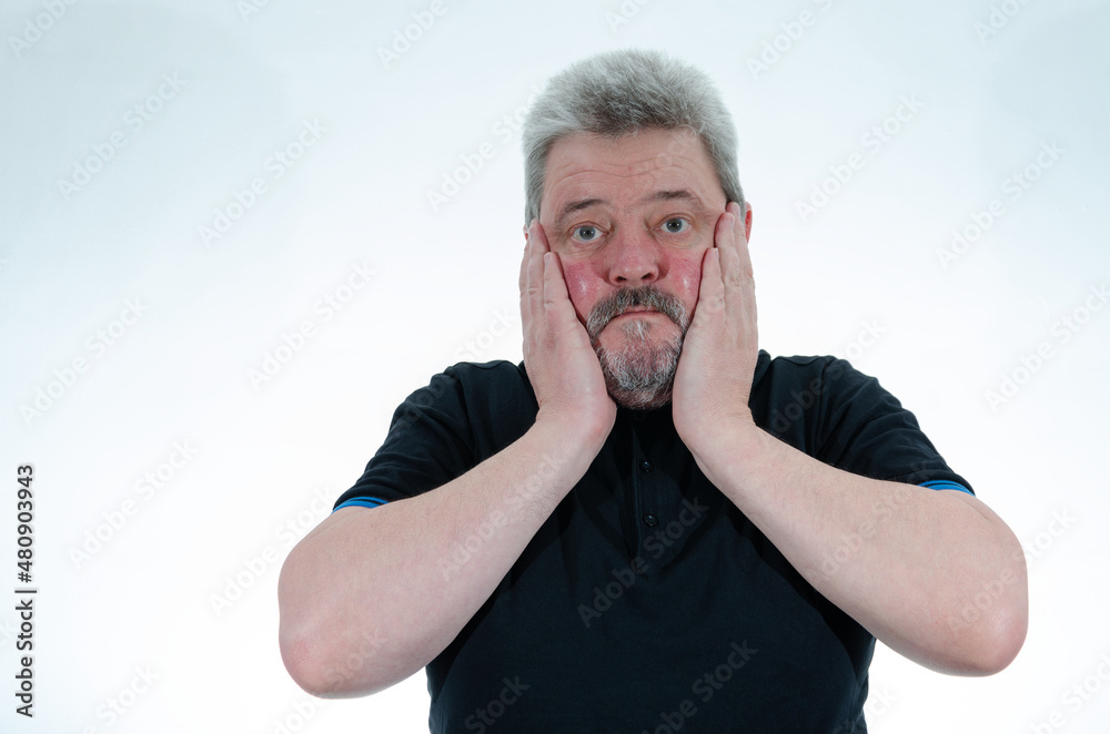 A man holds his head in his hands