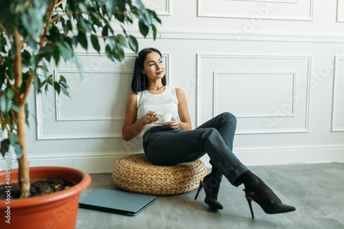 young Asian girl business style clothes, with a laptop