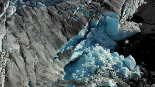 Aerial orbit around Knik Glacier revealing a mysterious ice cave in Alaska. photo
