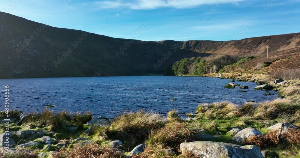 Lough Bray, Wicklow, Ireland. January 2022 Drone tracks south while ascending along the eastern shore of the lower lake with the Eagles Crag lookout point and Kippure mountain in the background.