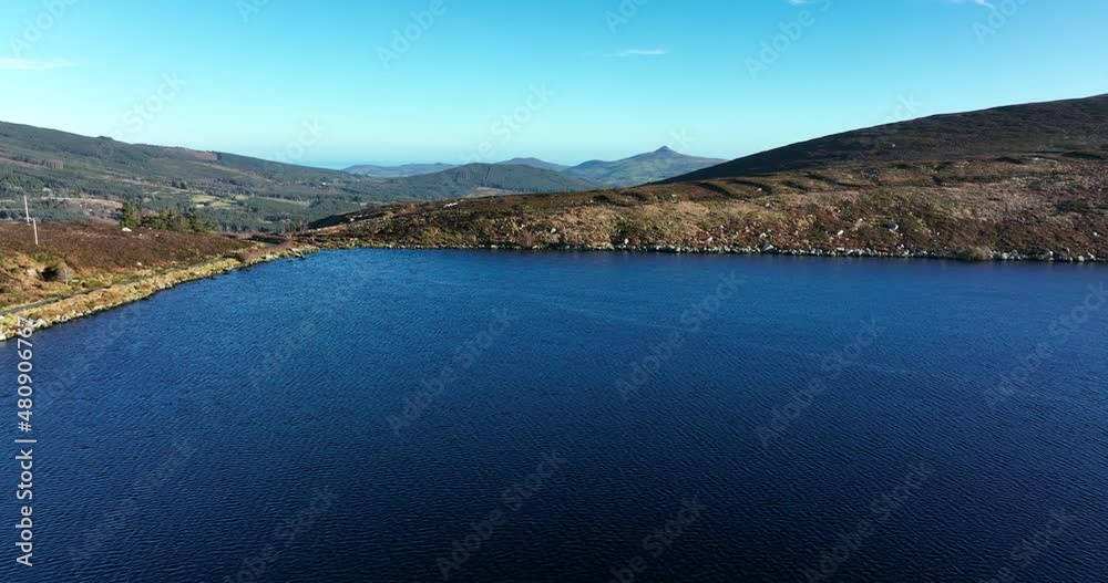 Lough Bray, Wicklow, Ireland. January 2022 Drone pushes east while slowly ascending above the lower lake towards Enniskerry with Kilmacanoge and the Great Sugarloaf mountain in the distance. Lough Bray, Wicklow, Ireland. January 2022 Drone pushes east while slowly ascending above the lower lake towards Enniskerry with Kilmacanoge and the Great Sugarloaf mountain in the distance.