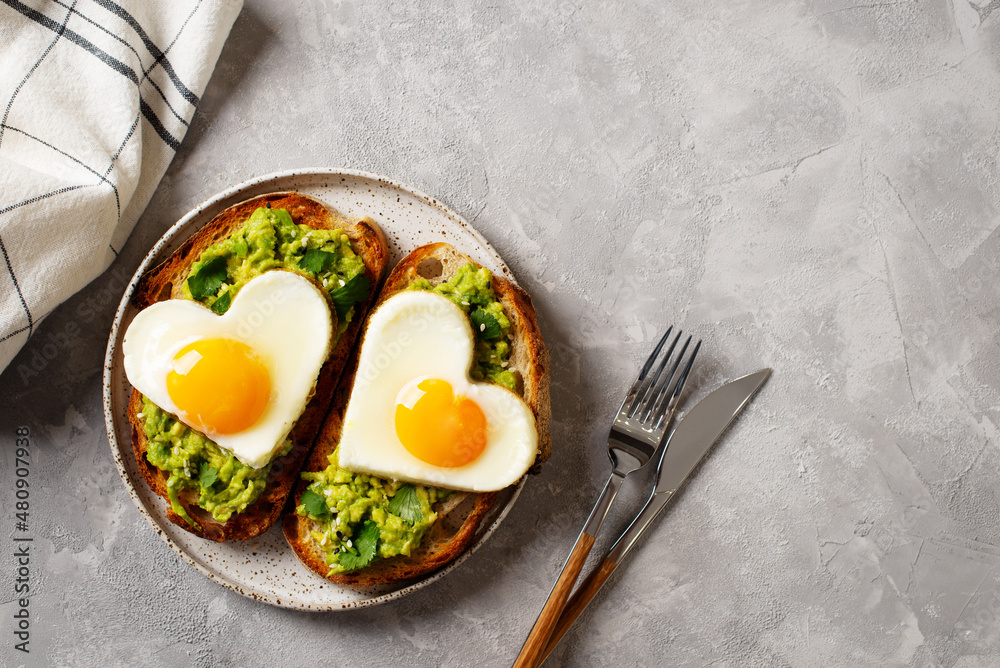 Healthy breakfast with eggs hearts and cup of coffee on grey background Healthy breakfast with eggs hearts and cup of coffee on grey background