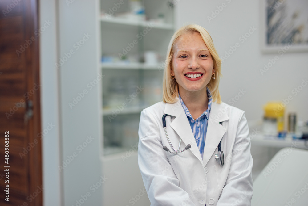 Smiling young female doctor, enjoying helping and curing people.