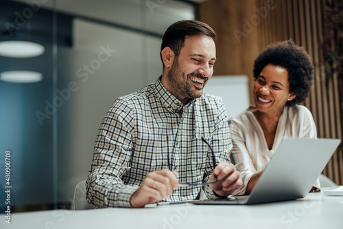 Relaxed coworkers talking to their client online, from the office. photo