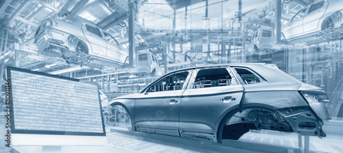 Fotografering Production in the automotive industry with assembly lines, car bodies and screen