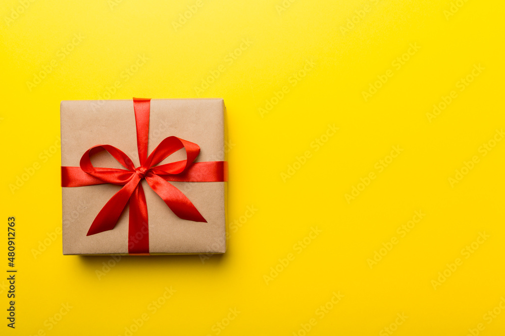 Holiday present box over colored background, top view. Copy space for design Holiday present box over colored background, top view. Copy space for design