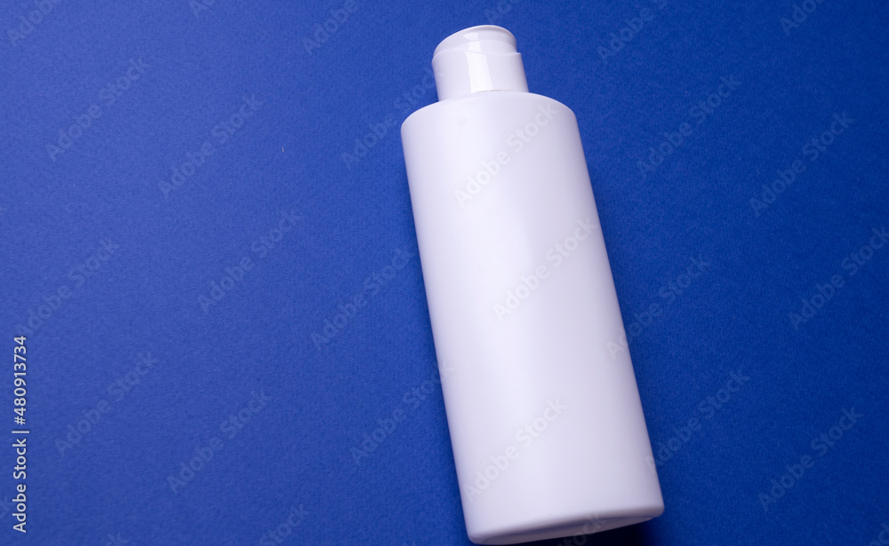 shampoo or hair conditioner bottle isolated on blue background shampoo or hair conditioner bottle isolated on blue background