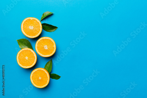 fresh Fruit orange slices on colored background. Top view. Copy Space. creative summer concept. Half of citrus in minimal flat lay with copy space © sosiukin