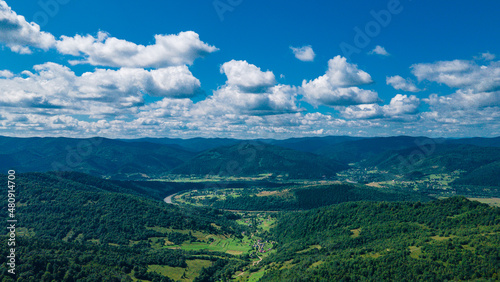 Fototapeta Naklejka Na Ścianę i Meble -  mountains aerial view in blue sky clouds