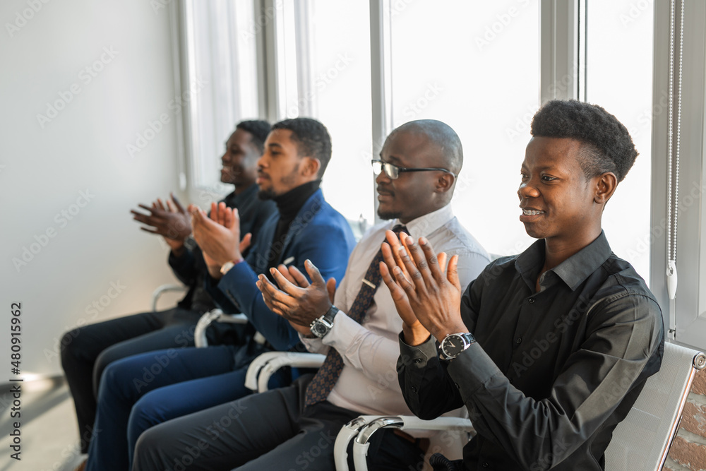 Fototapeta premium cheering group of young african men in office