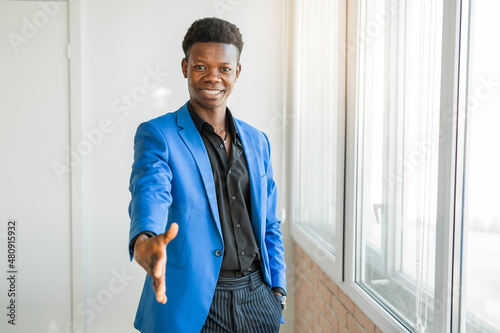 cheerful african male in suit with greeting gesture 
