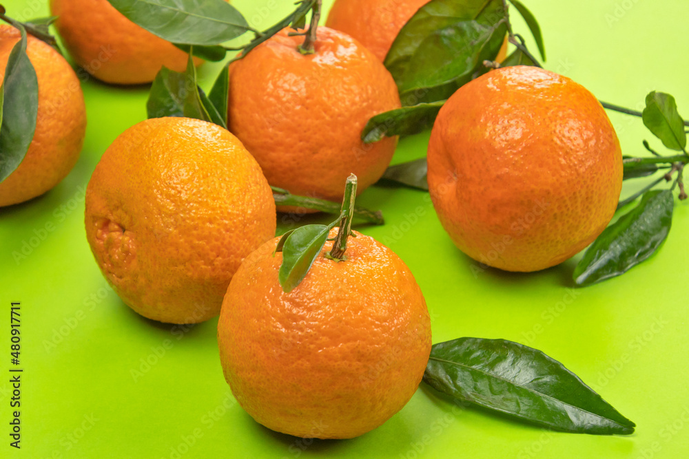 several isolated clementines on a green background several isolated clementines on a green background