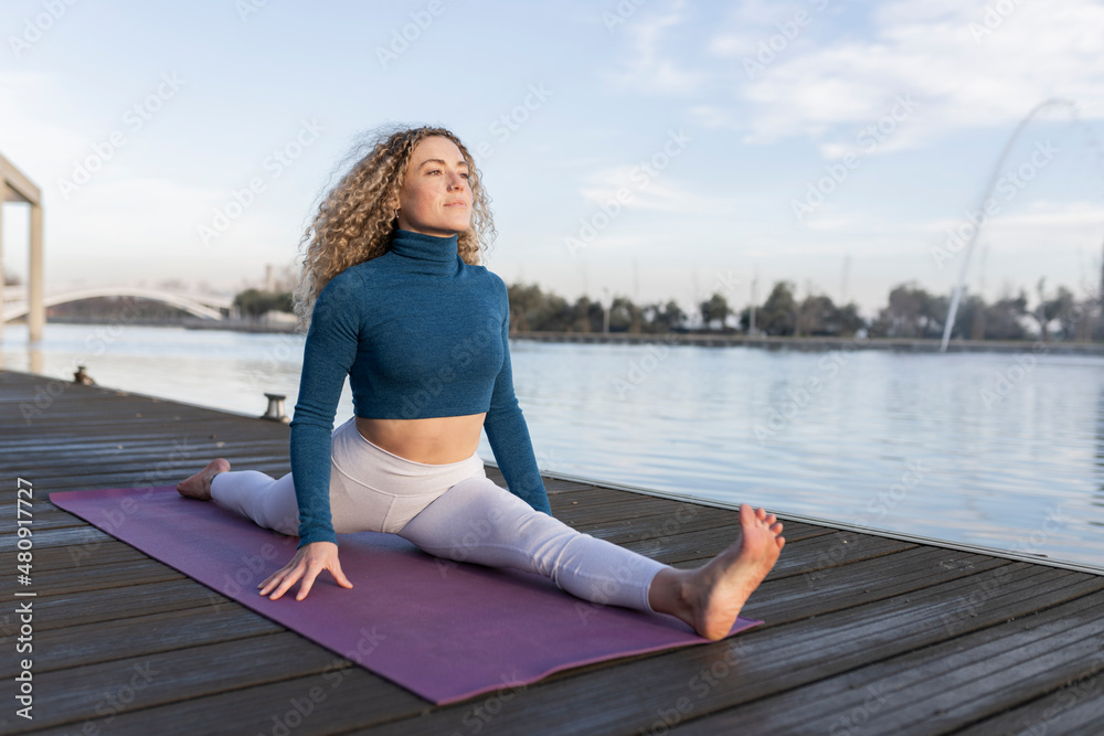 happy smiling woman doing exercises in park, yoga teacher