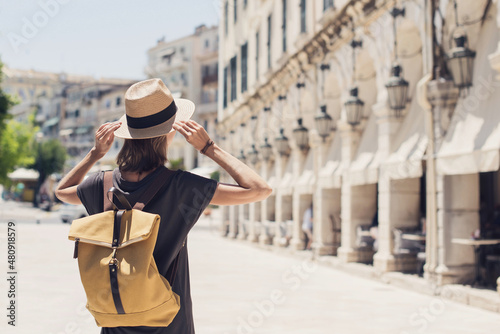 Travel concept, beautiful tourist woman walking in Kerkyra old town during vacation, cheerful student girl traveling abroad in summer, Corfu island, Greece  photo
