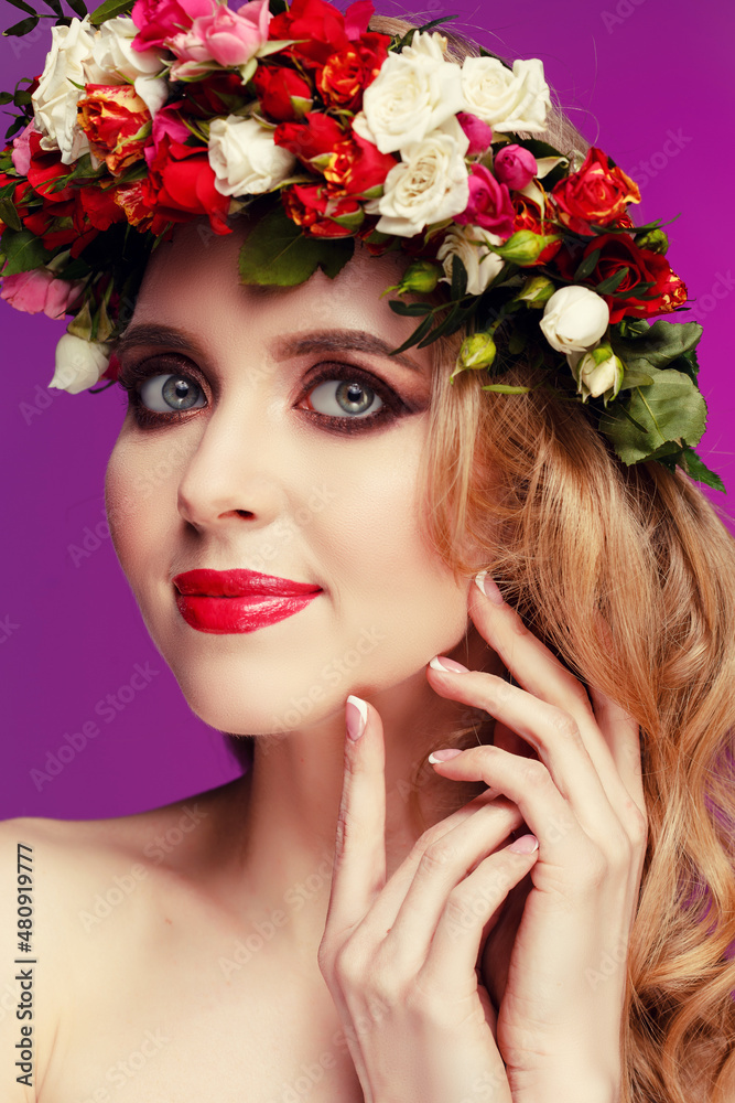 Girl with flowers. Woman with spring blooming wreath. Model and flowers. Summer lady