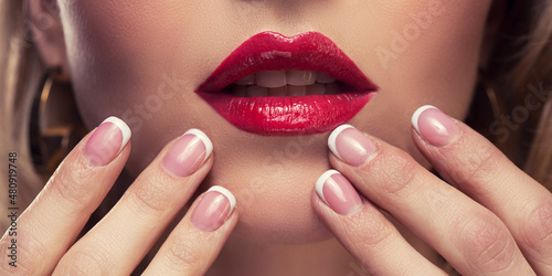 Female lips painted with red lipstick. Sexy lips of a woman. Makeup for a girl