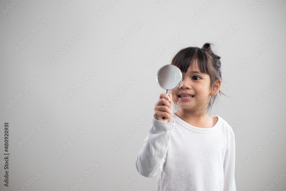 little girl looking through a magnifying glass little girl looking through a magnifying glass