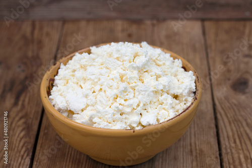 farm cottage cheese in a bowl on the wooden table