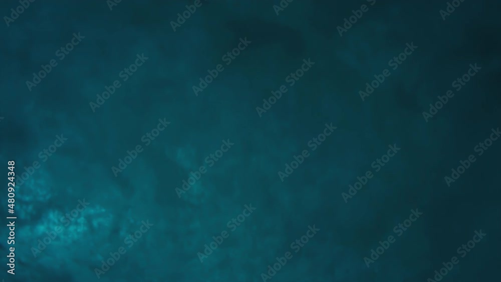 Ocean wave breaks with splashes on the camera