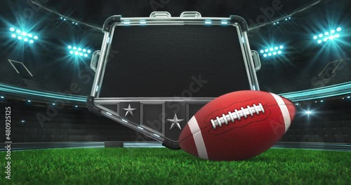 Rolling American football ball and steel shield with empty space for advertisement text. Green grass field and illuminated sport arena with light flashes. Two 4K video parts of loopable sport intro. photo