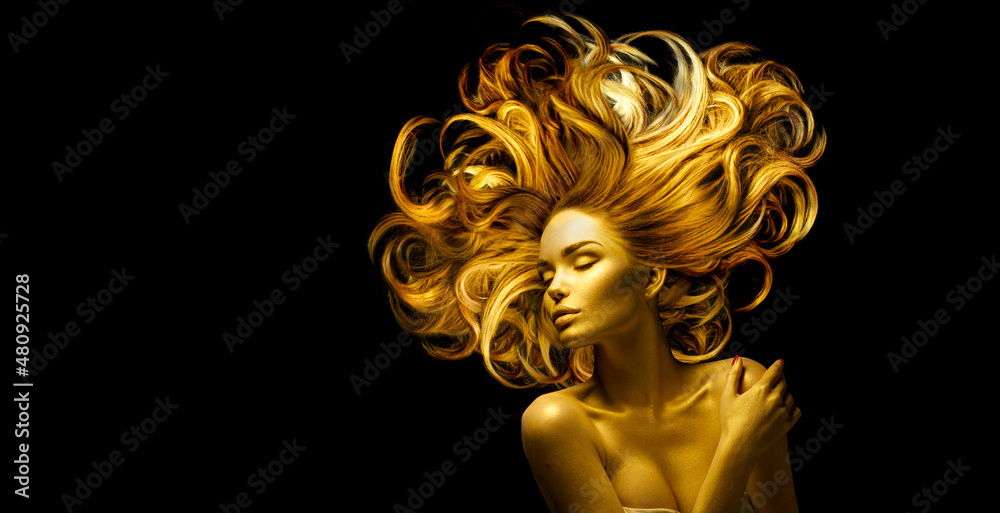 Gold Woman skin and hair, Beauty model girl with Golden make up, Long hair  on black background. Gold glowing skin and fluttering hair. Metallic,  glance Fashion art portrait, hairstyle, art design Stock