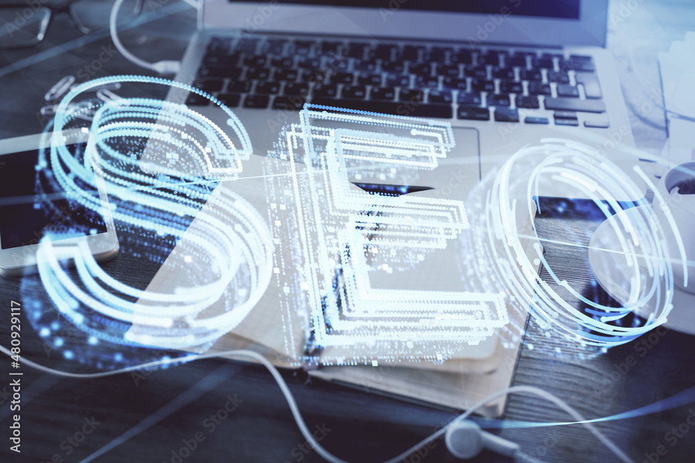 Multi exposure of SEO drawings and desk with open notebook background. Concept of Search optimization Multi exposure of SEO drawings and desk with open notebook background. Concept of Search optimization