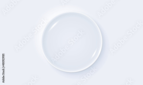 White plate on white table. Top view. 