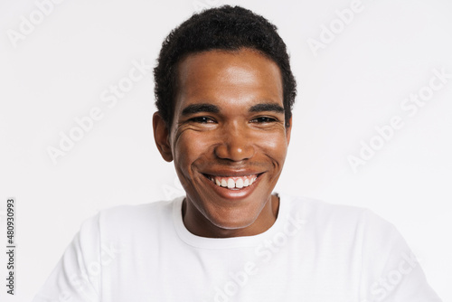 Young black man in t-shirt smiling and looking at camera